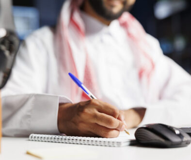 Muslim guy writing down research notes